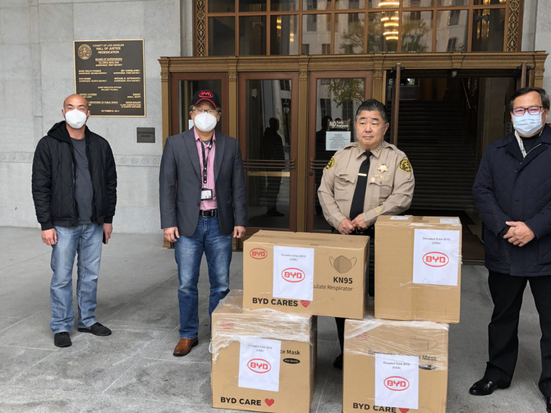 BYD employees with boxes of PPE