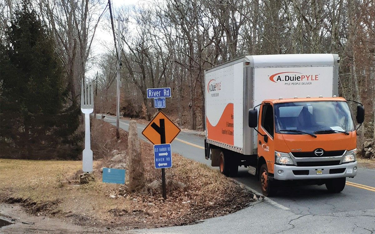 A. Duie Pile truck driving down road