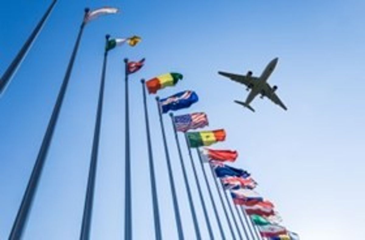 iata plane-flying-over-flags.jpeg