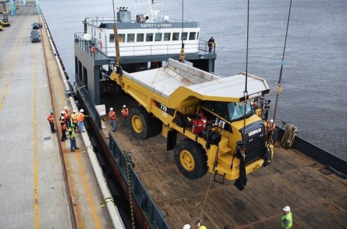 Workers at JAXPORT's Talleyrand Marine Terminal move massive trucks bound for the Bahamas