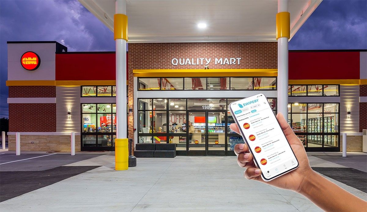 Person holding cell phone in front of store