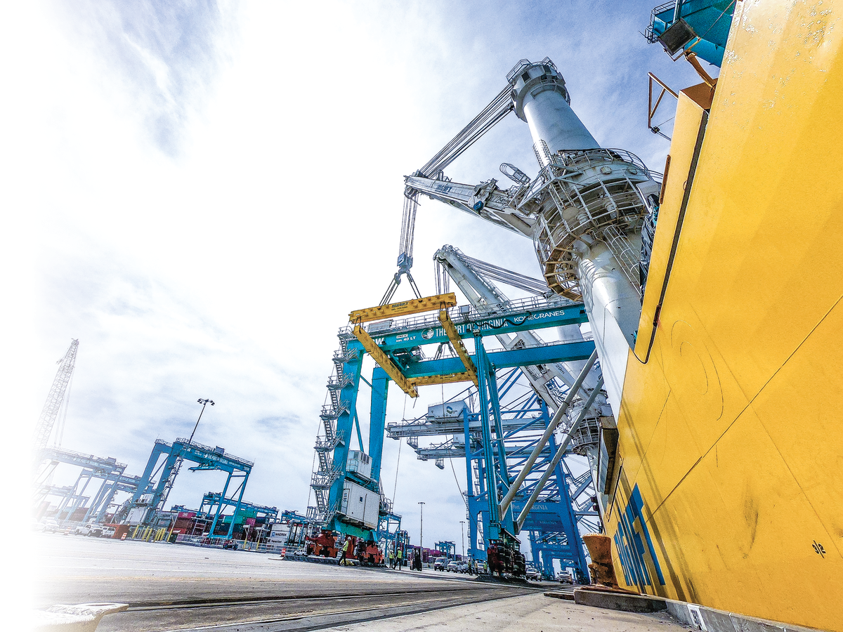 Ship at dock next to cranes